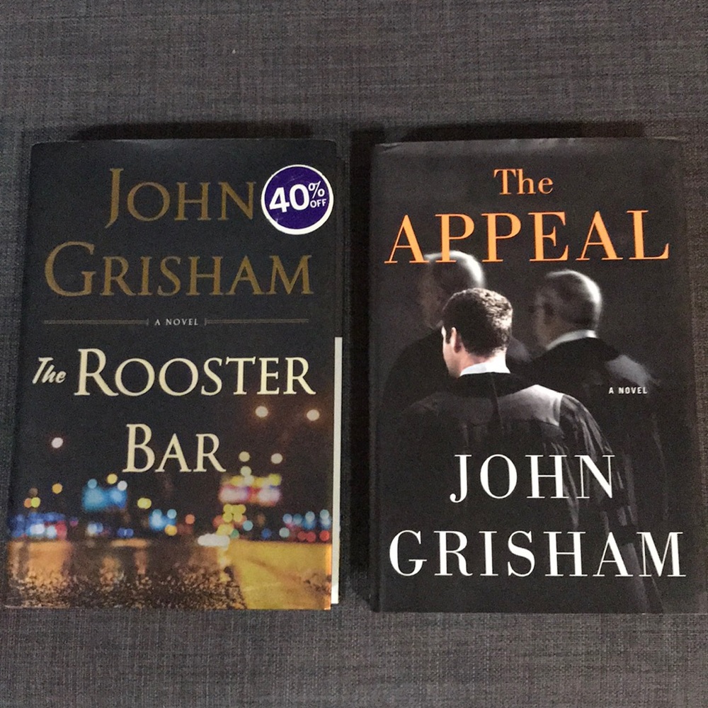 Two hardcover John Grisham novels